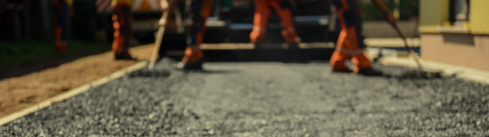 team of workers asphalting a driveway